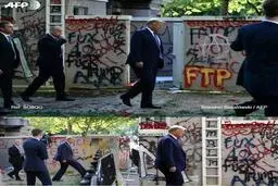  ترامپ در مقابل دیوارهایی پر از شعار+عکس