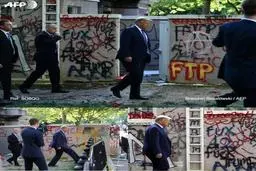  ترامپ در مقابل دیوارهایی پر از شعار+عکس